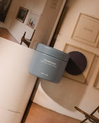 Blue Hairsauce Texture Balm cylindrical jar on an architectural book with natural tones